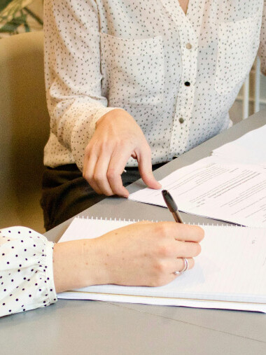 Professionals reviewing and comparing talent proposal documents for a healthcare campaign