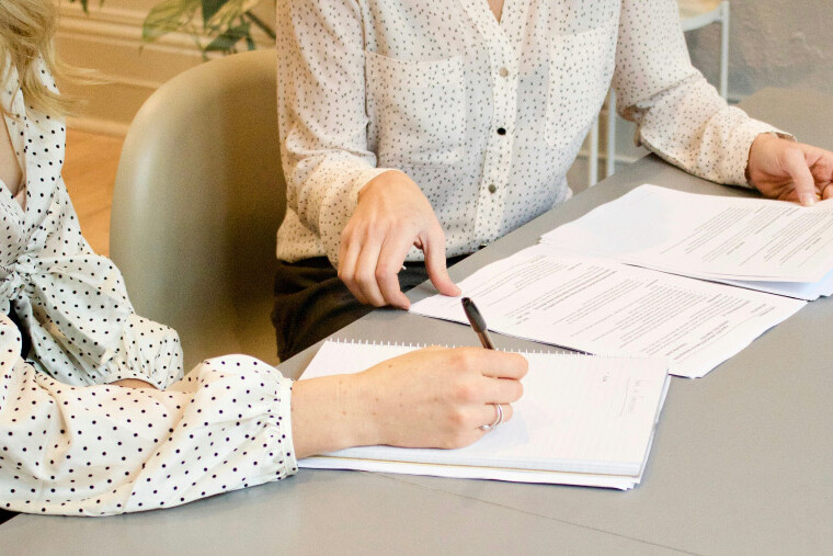 Professionals reviewing and comparing talent proposal documents for a healthcare campaign