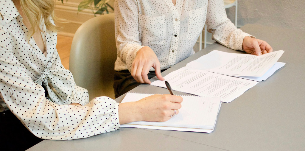 Professionals reviewing and comparing talent proposal documents for a healthcare campaign