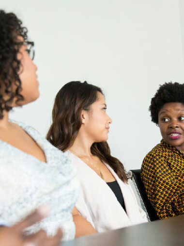 Community stakeholders discussing a healthcare campaign around a table