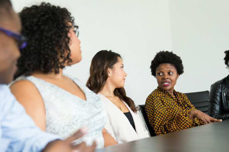 Community stakeholders discussing a healthcare campaign around a table