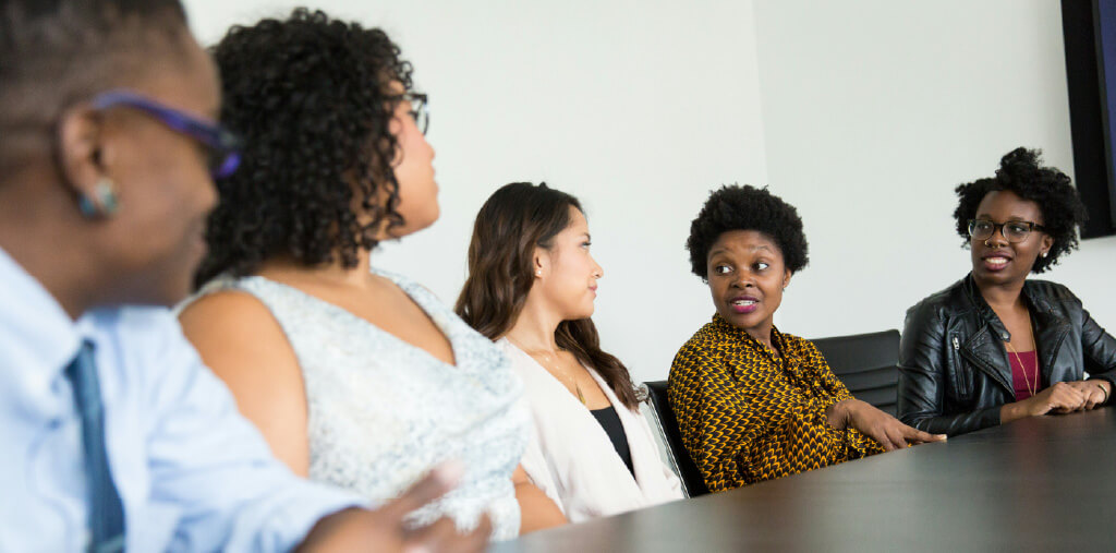 Community stakeholders discussing a healthcare campaign around a table